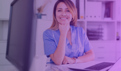 Nurse looking at camera smiling with hand on her chin